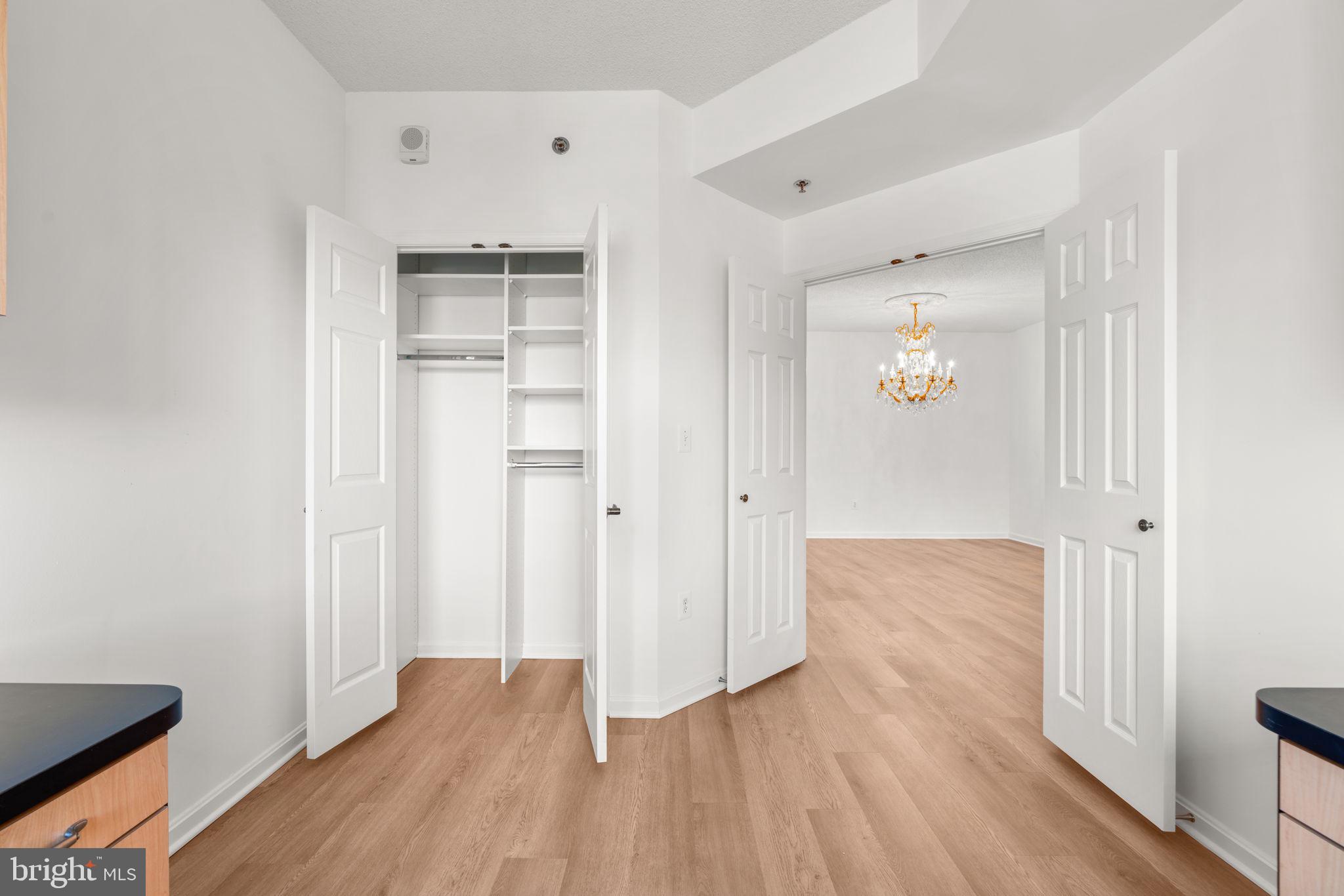 2901 South Leisure World Boulevard, Unit 233 Silver Spring, MD 20906 - Photo 17 of 43 an empty room with wooden floor and windows