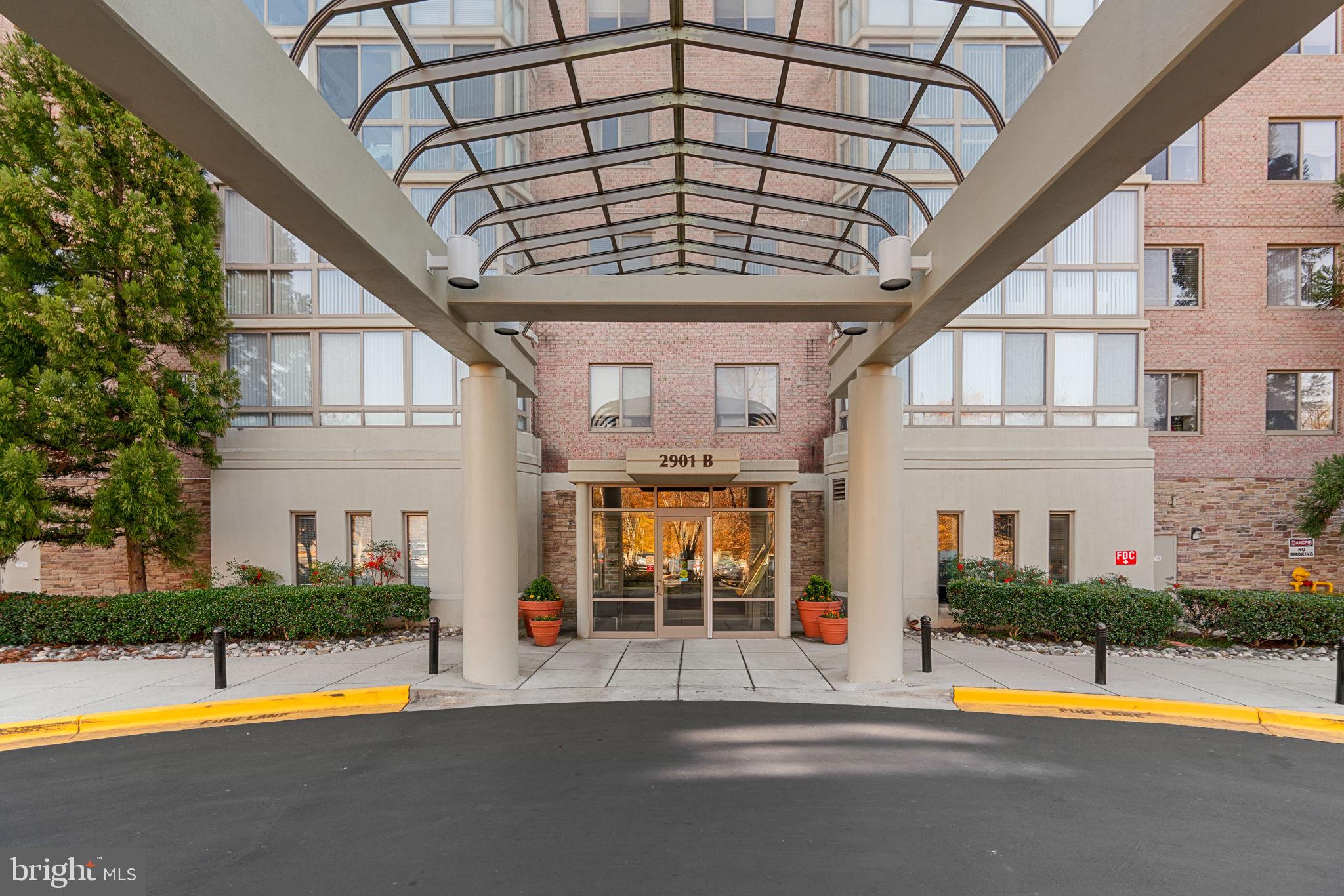 2901 South Leisure World Boulevard, Unit 233 Silver Spring, MD 20906 - Photo 2 of 43 a view of swimming pool with a patio and yard of the house