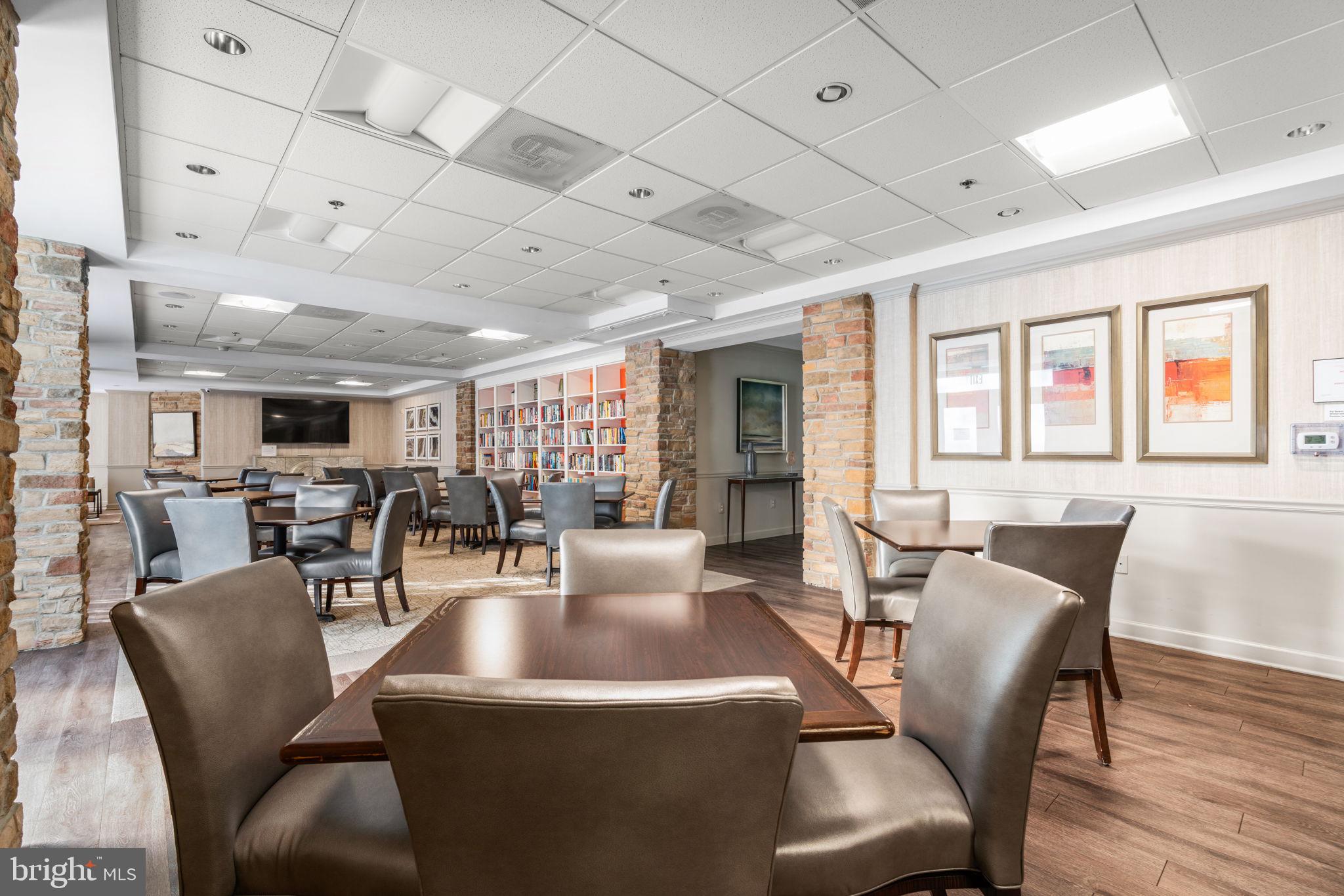 2901 South Leisure World Boulevard, Unit 233 Silver Spring, MD 20906 - Photo 32 of 43 a dining room with furniture a rug and wooden floor