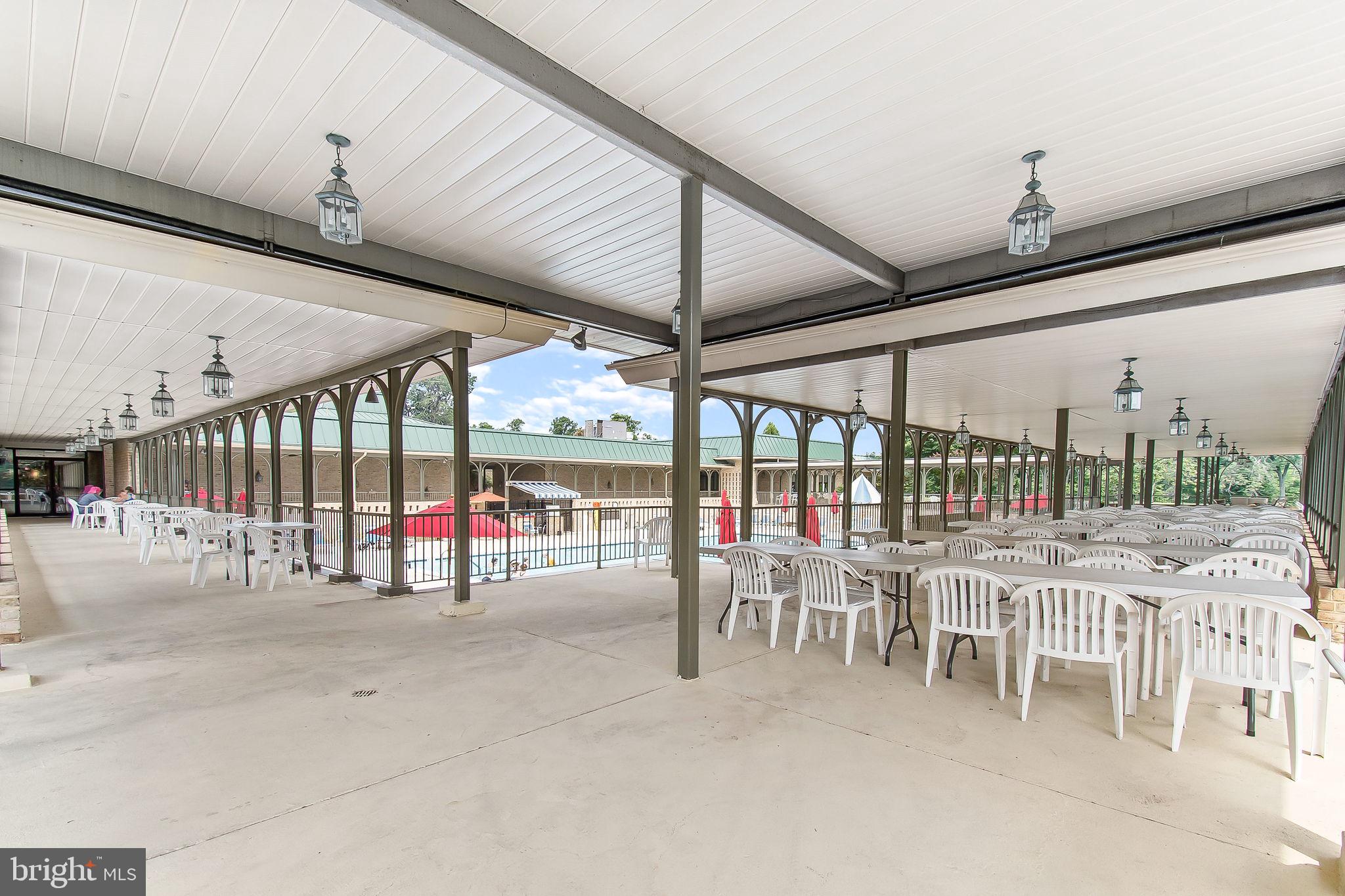 2901 South Leisure World Boulevard, Unit 233 Silver Spring, MD 20906 - Photo 41 of 44 a view of a patio with a table and chairs