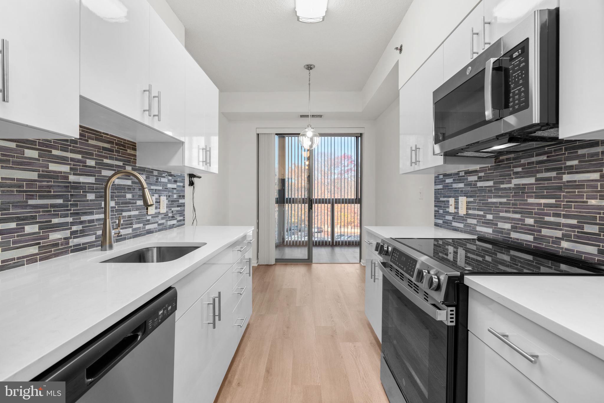 2901 South Leisure World Boulevard, Unit 233 Silver Spring, MD 20906 - Photo 9 of 43 a kitchen with stainless steel appliances granite countertop a sink stove and cabinets