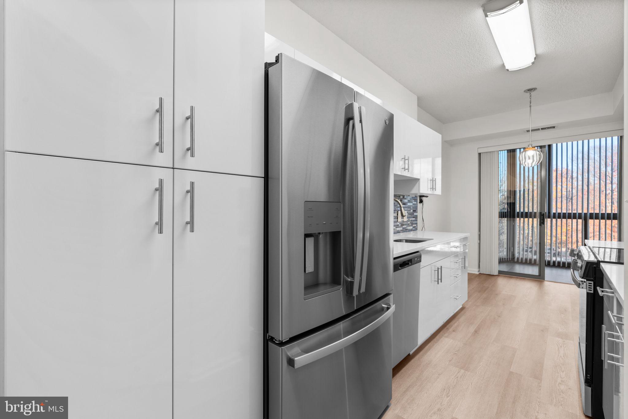 2901 South Leisure World Boulevard, Unit 233 Silver Spring, MD 20906 - Photo 10 of 43 a kitchen with stainless steel appliances a refrigerator and a sink