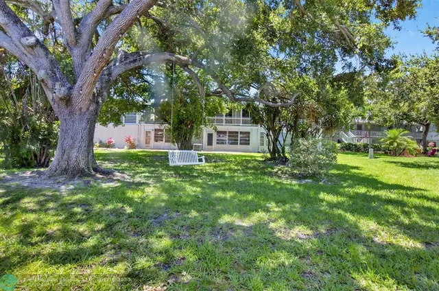 an aerial view of a house with a swimming pool and garden