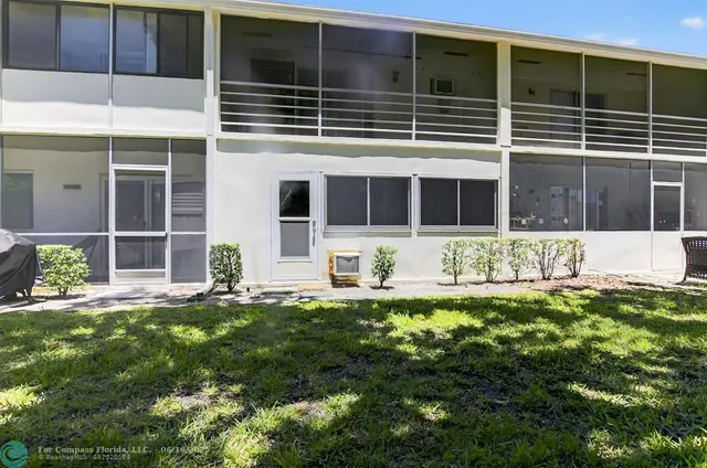 an aerial view of residential houses with outdoor space and river
