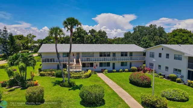 an aerial view of a house with garden space and street view