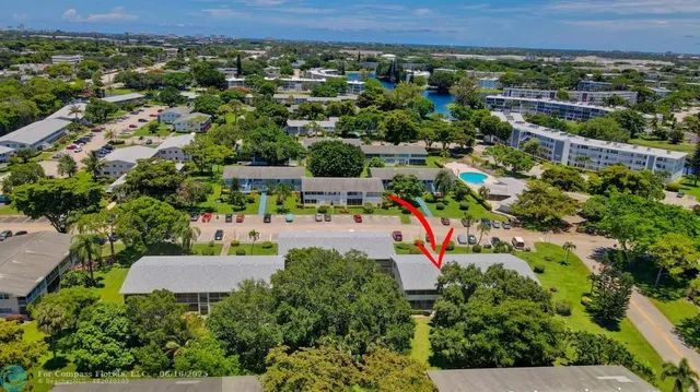 an aerial view of residential houses with outdoor space and swimming pool