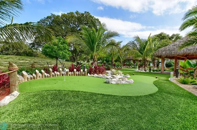 a view of a dining hall with lots of tables a large window and furniture