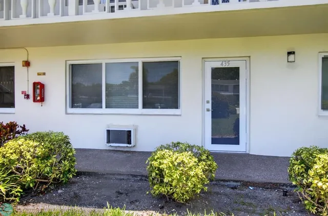 a living room with furniture and painting on the wall