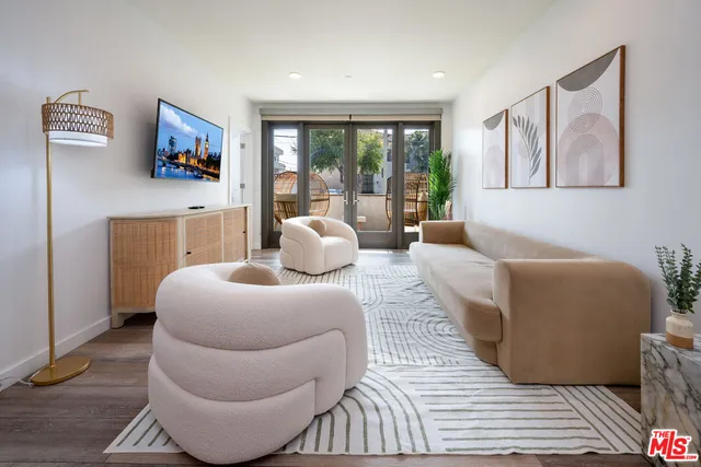 a living room with furniture and a floor to ceiling window
