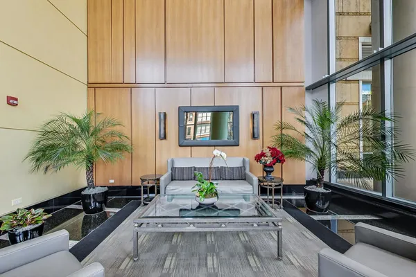 a living room with furniture and a potted plant