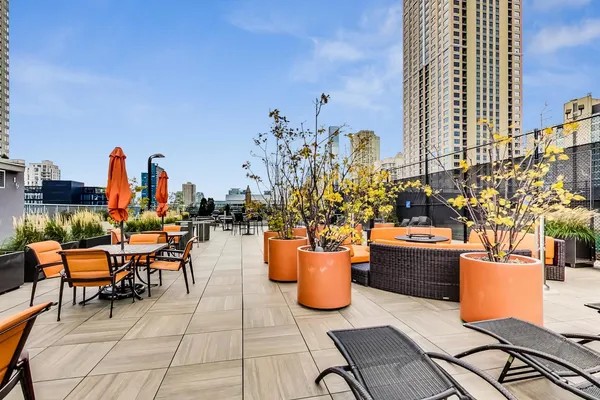 a view of a patio with dining table and chairs potted plants
