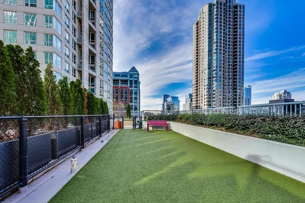 a view of a city with tall buildings and a big yard