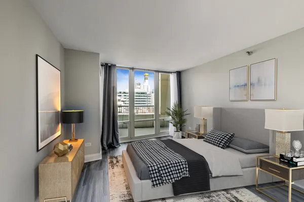 a bedroom with a bed and wooden floor