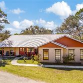 a front view of a house with swimming pool and porch