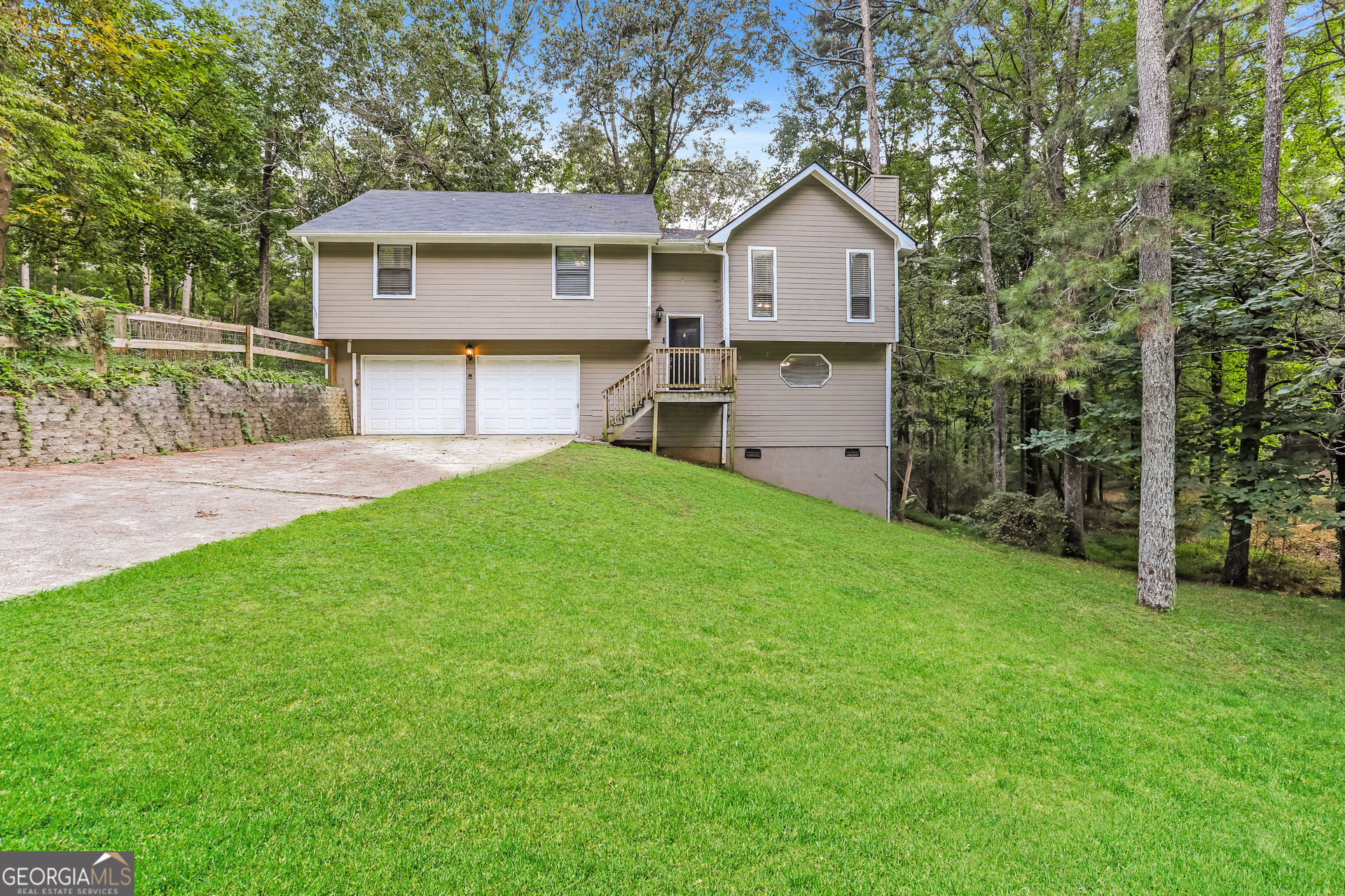 a view of a house with a yard and sitting area