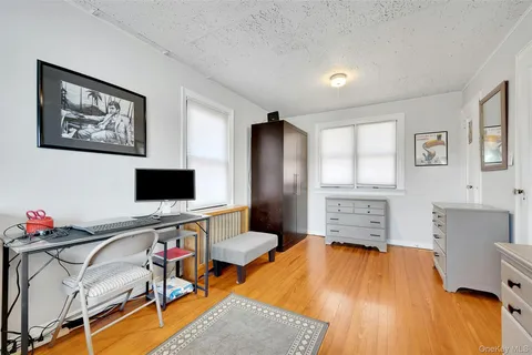 a view of hallway with a large window and wooden floor
