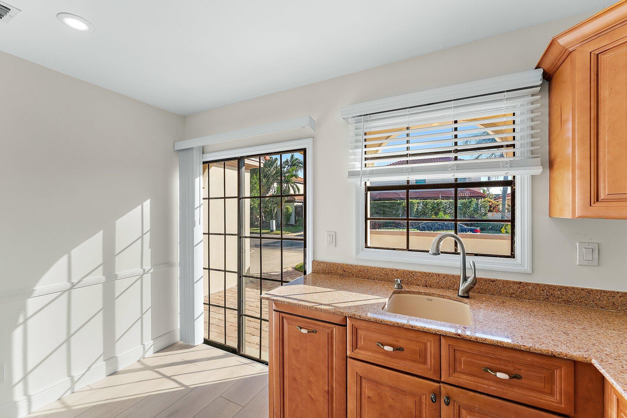 1483 Vía Del Sol Jupiter, FL 33477 - Photo 12 of 17 a kitchen with a sink and large window