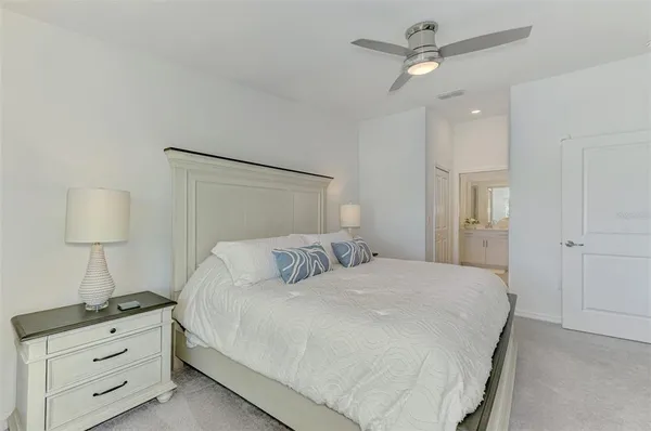 a bedroom with a bed and a night stand