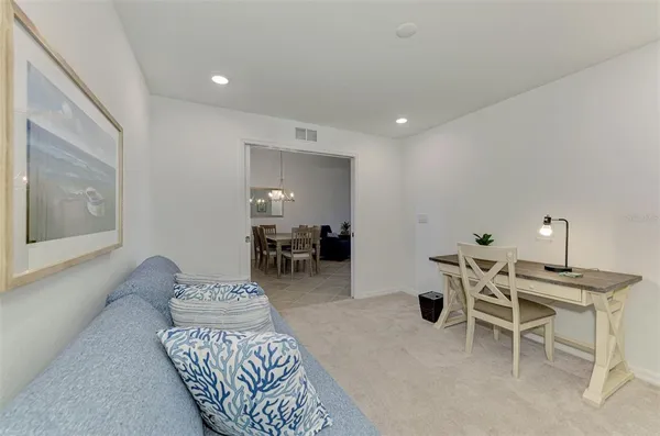 a living room with furniture a dining table and a large window