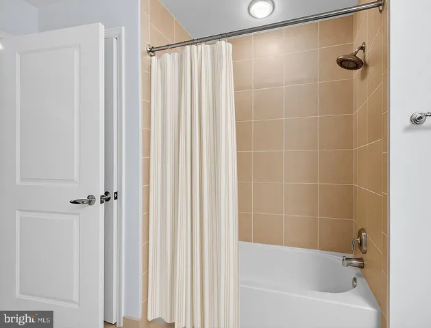 a bathroom with a shower and a tub