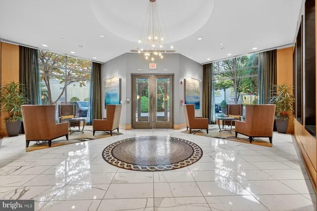 a living room with furniture and a chandelier