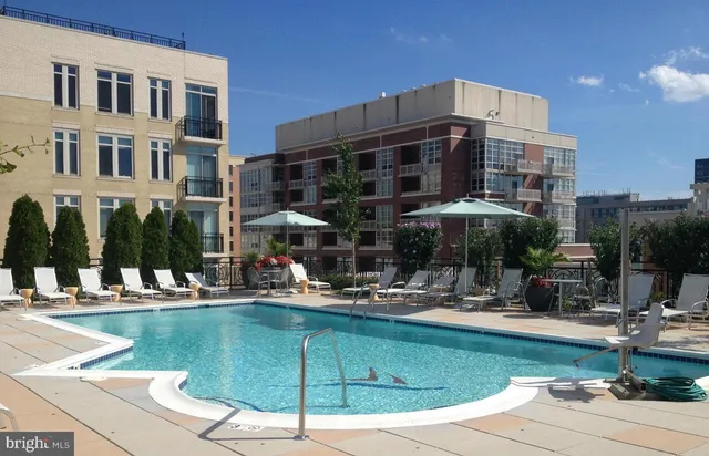 a swimming pool with outdoor seating yard and barbeque oven