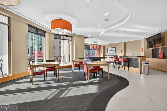 a living room filled with furniture and a potted plant