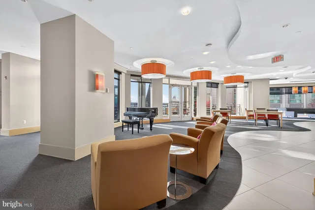 a living room with furniture a rug and white walls