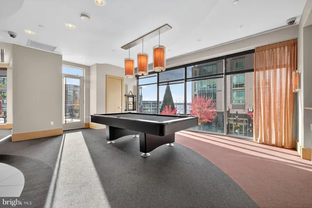 a room with pool table and sofas