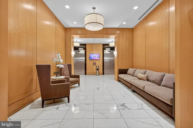 a living room with furniture and a chandelier