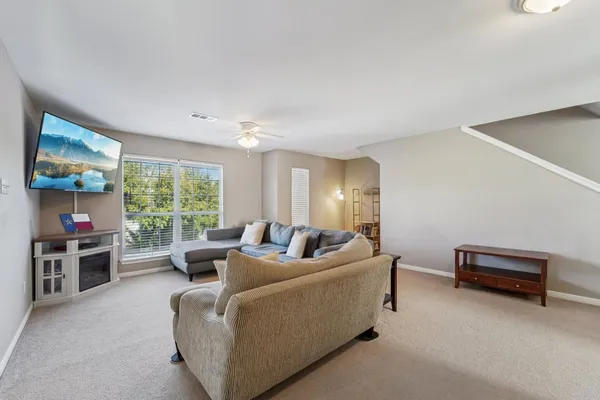 a living room with furniture and a large window