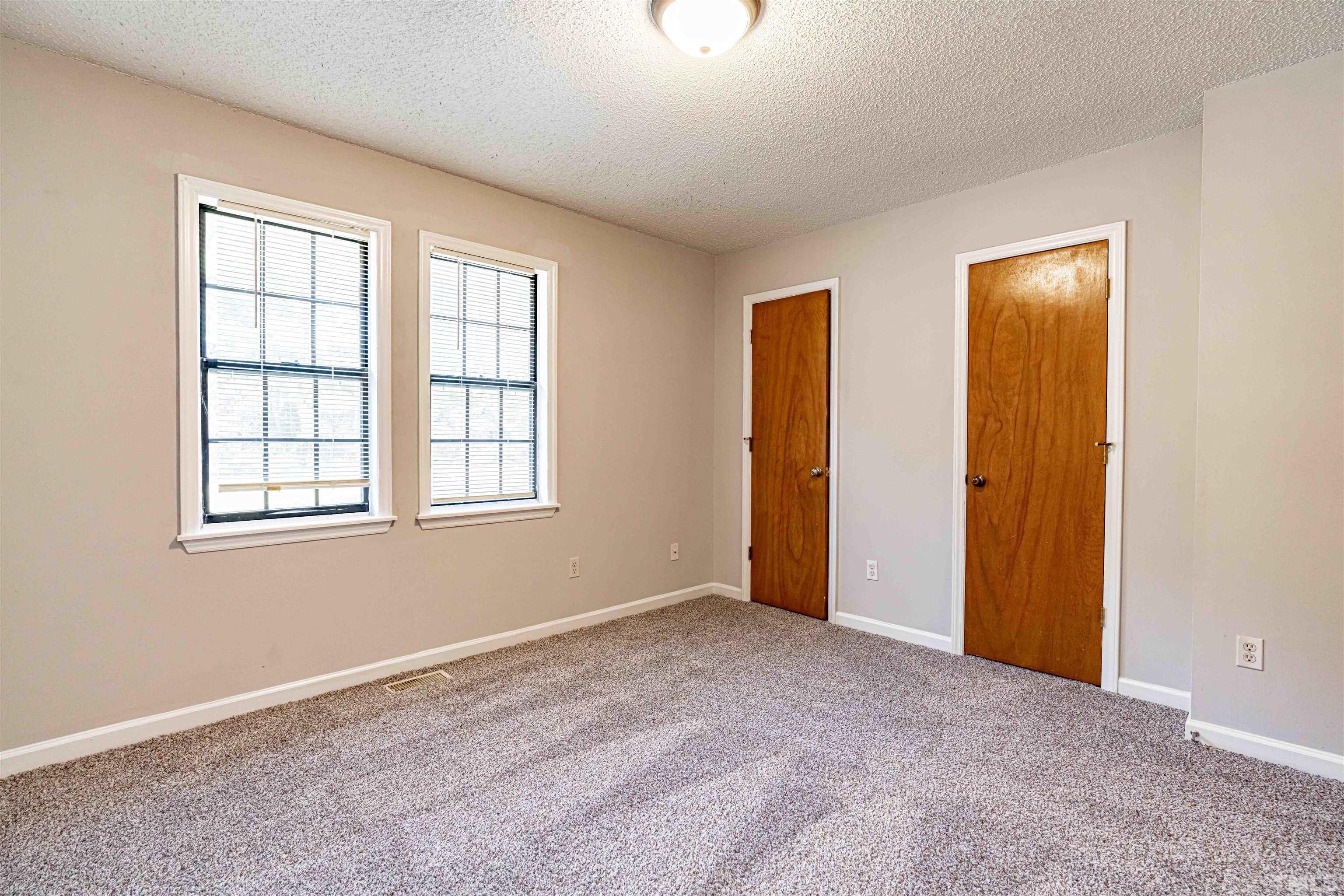 1722 Fox Hollow Drive Raleigh, NC 27610 - Photo 12 of 18 an empty room with windows and closet