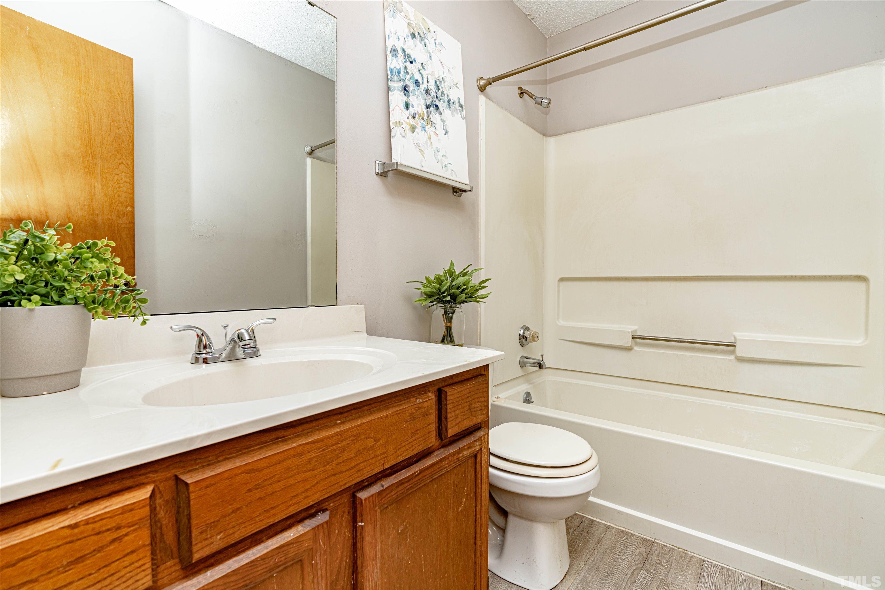 1722 Fox Hollow Drive Raleigh, NC 27610 - Photo 15 of 18 a bathroom with a sink a toilet and shower