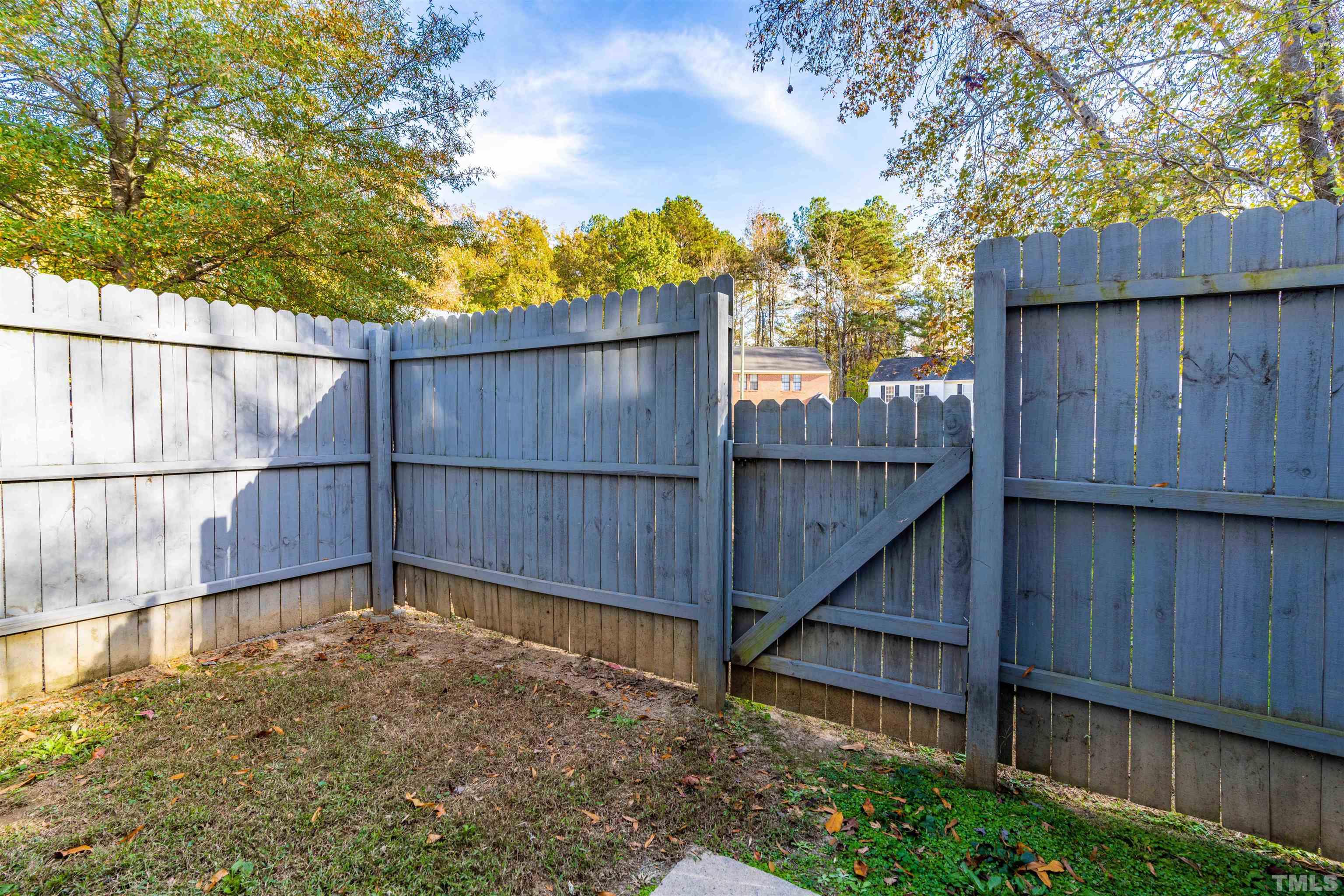 1722 Fox Hollow Drive Raleigh, NC 27610 - Photo 17 of 18 a view of a backyard with wooden fence and large trees