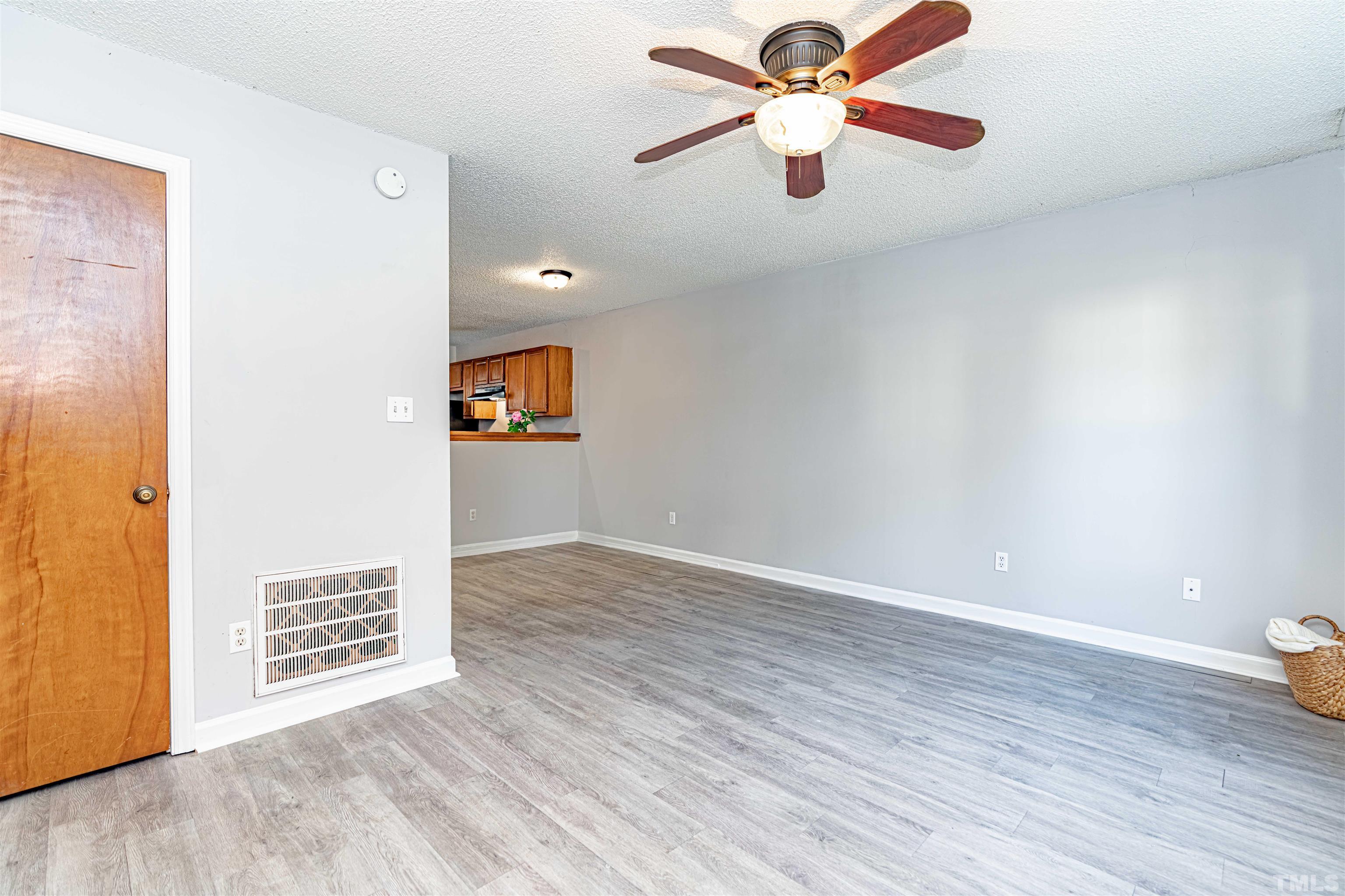 1722 Fox Hollow Drive Raleigh, NC 27610 - Photo 3 of 18 a view of a room with wooden floor and a ceiling fan