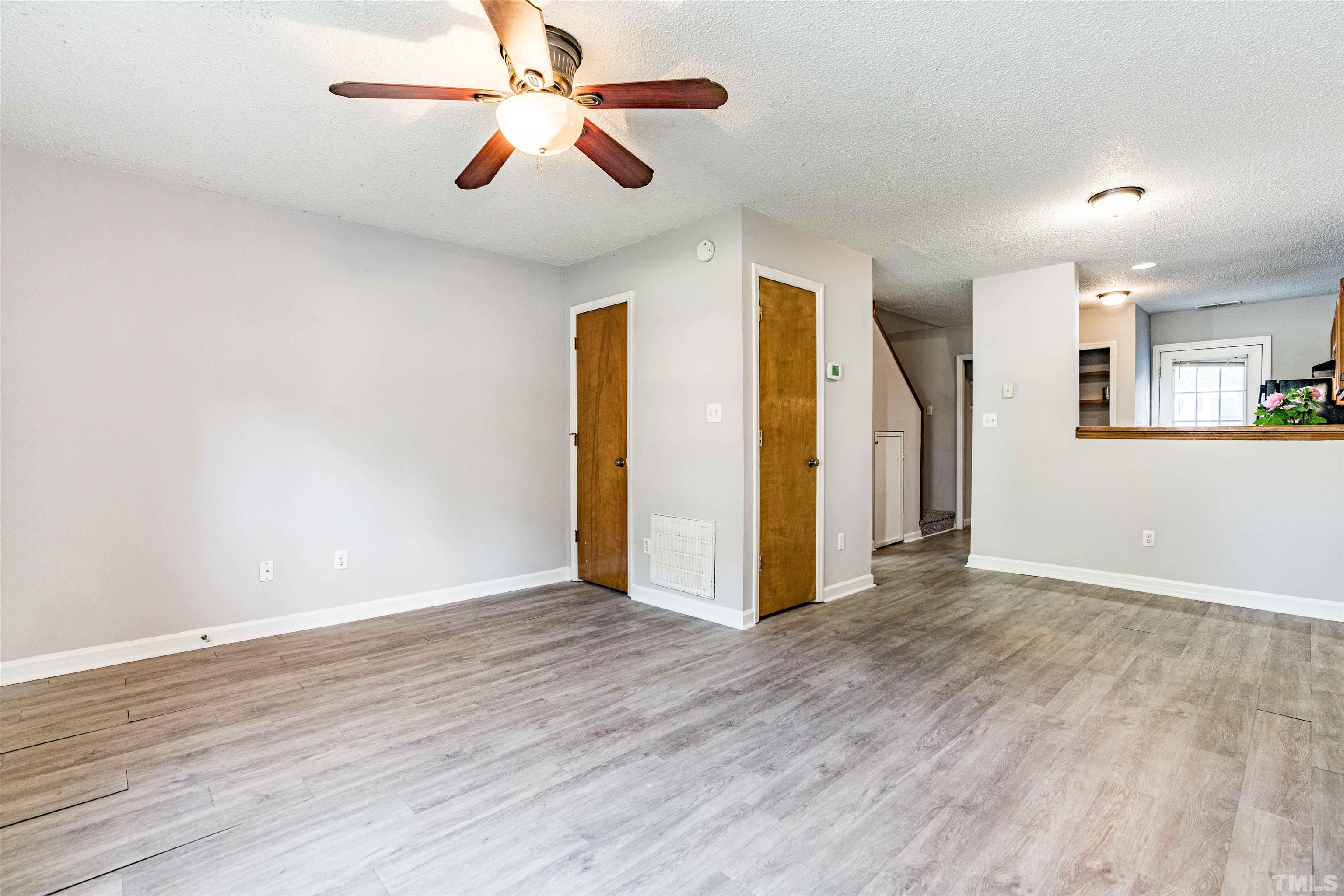 1722 Fox Hollow Drive Raleigh, NC 27610 - Photo 4 of 18 a view of an empty room with wooden floor