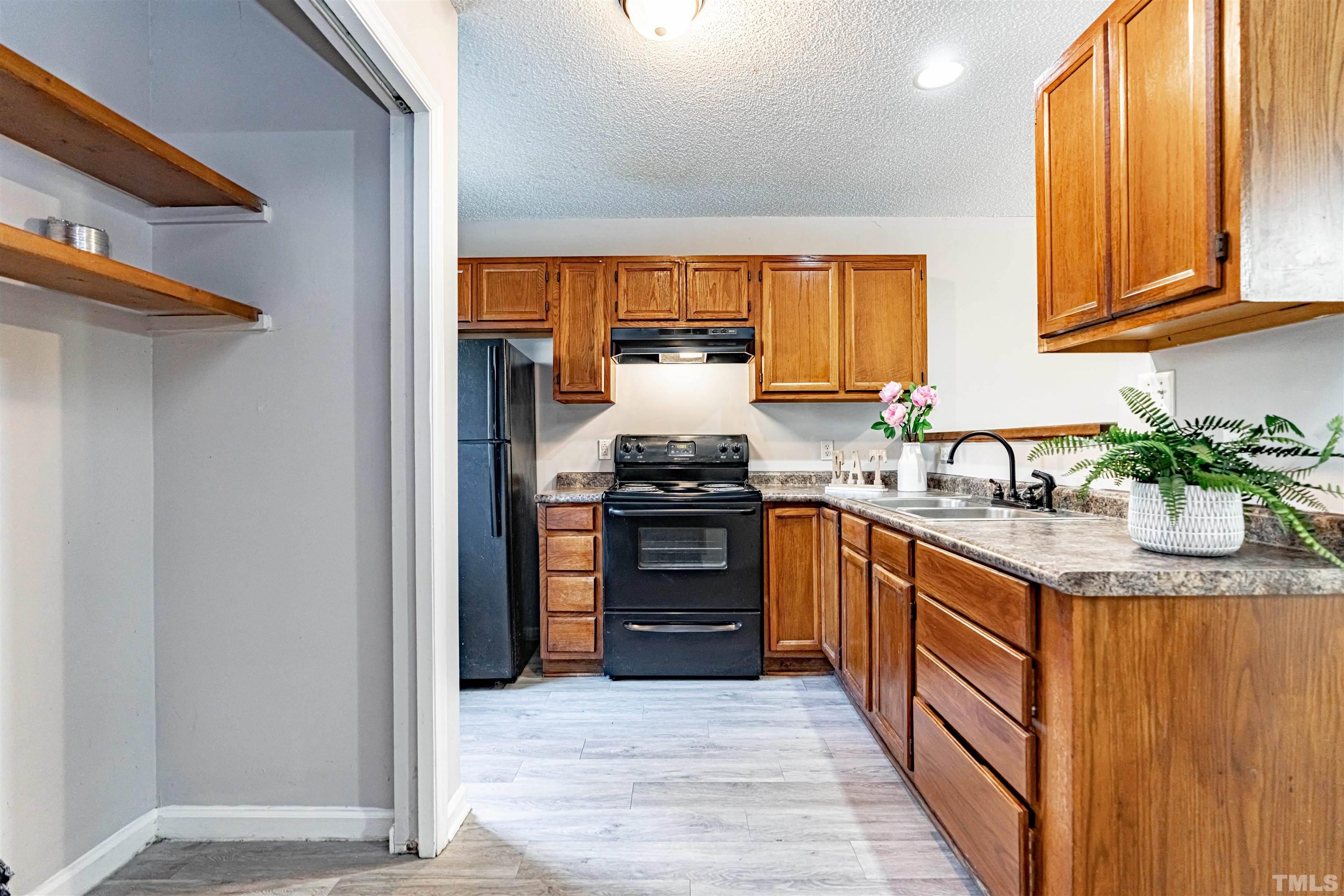 1722 Fox Hollow Drive Raleigh, NC 27610 - Photo 8 of 18 a kitchen with granite countertop a refrigerator and a stove