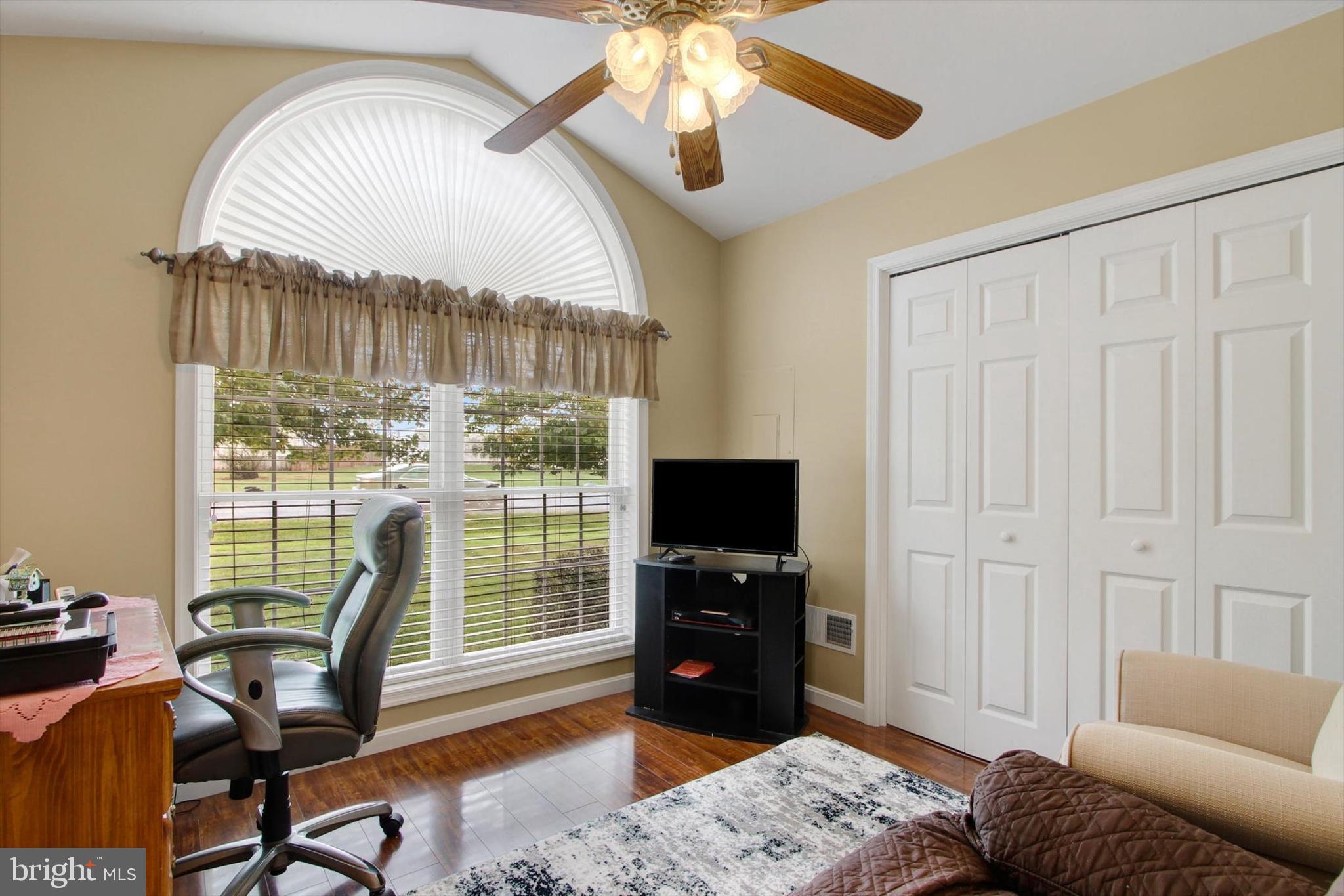 975 Hoffman Home Road Gettysburg, PA 17325 - Photo 14 of 28 a living room with furniture a flat screen tv and a large window