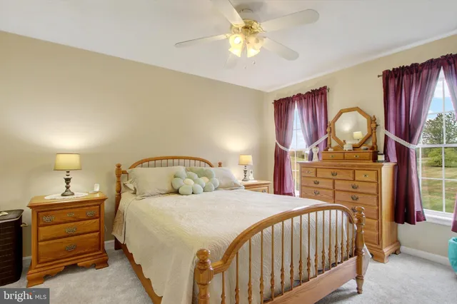 a bedroom with a bed and a mirror on the dresser