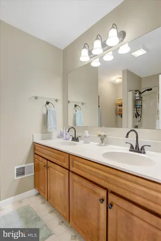 a bathroom with a sink vanity and a mirror