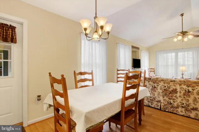 a view of a dining room with furniture and a chandelier
