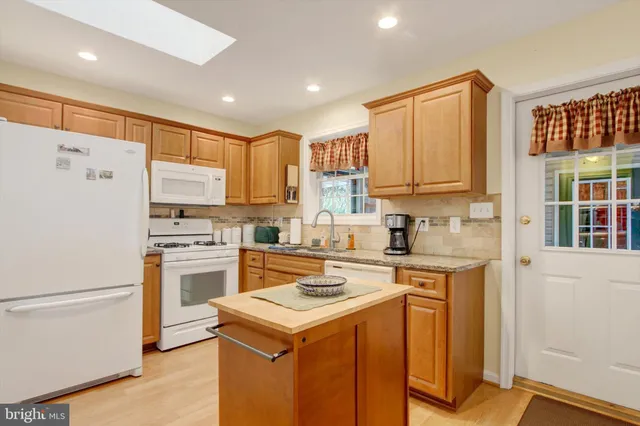 a kitchen with a stove a refrigerator and a sink