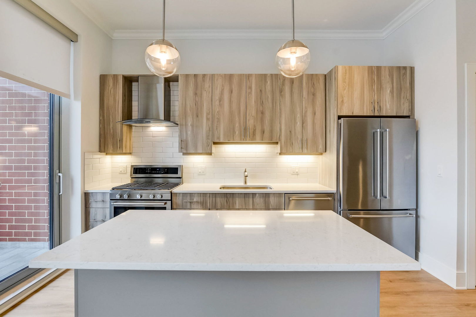 Undisclosed Address Chicago, IL 60607 - Photo 4 of 12 a kitchen with kitchen island a counter space a stove and refrigerator