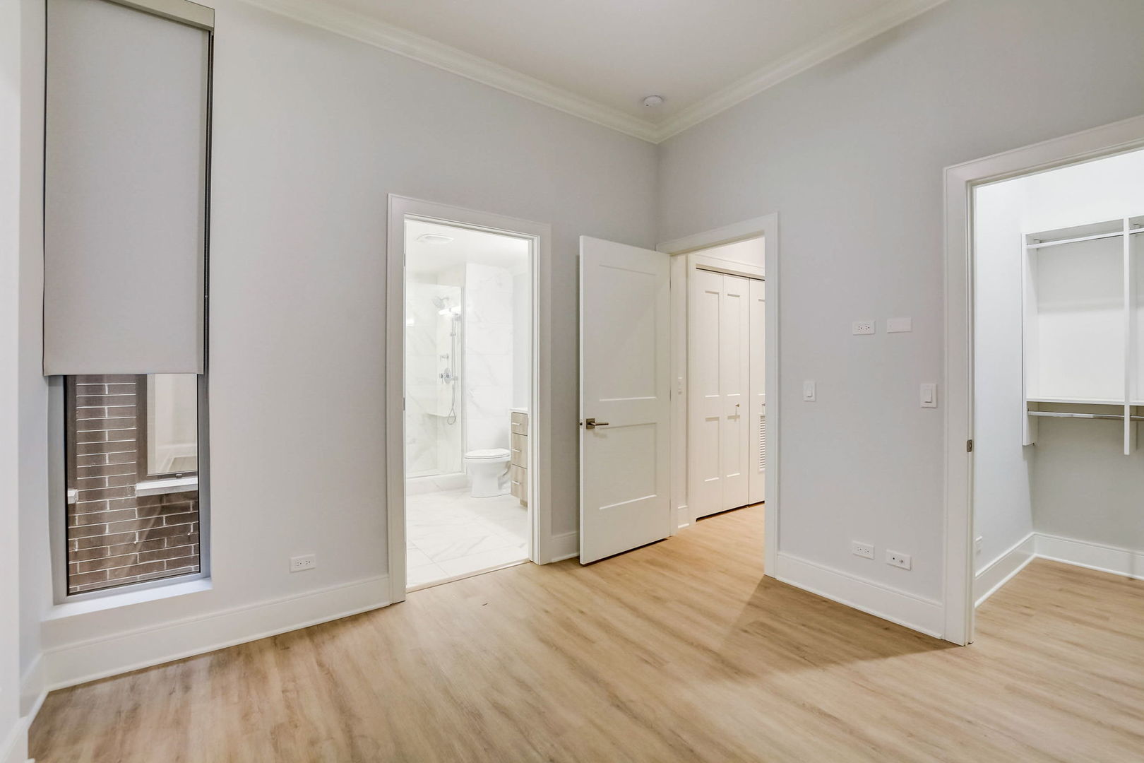 Undisclosed Address Chicago, IL 60607 - Photo 6 of 12 a view of an empty room with wooden floor and a window