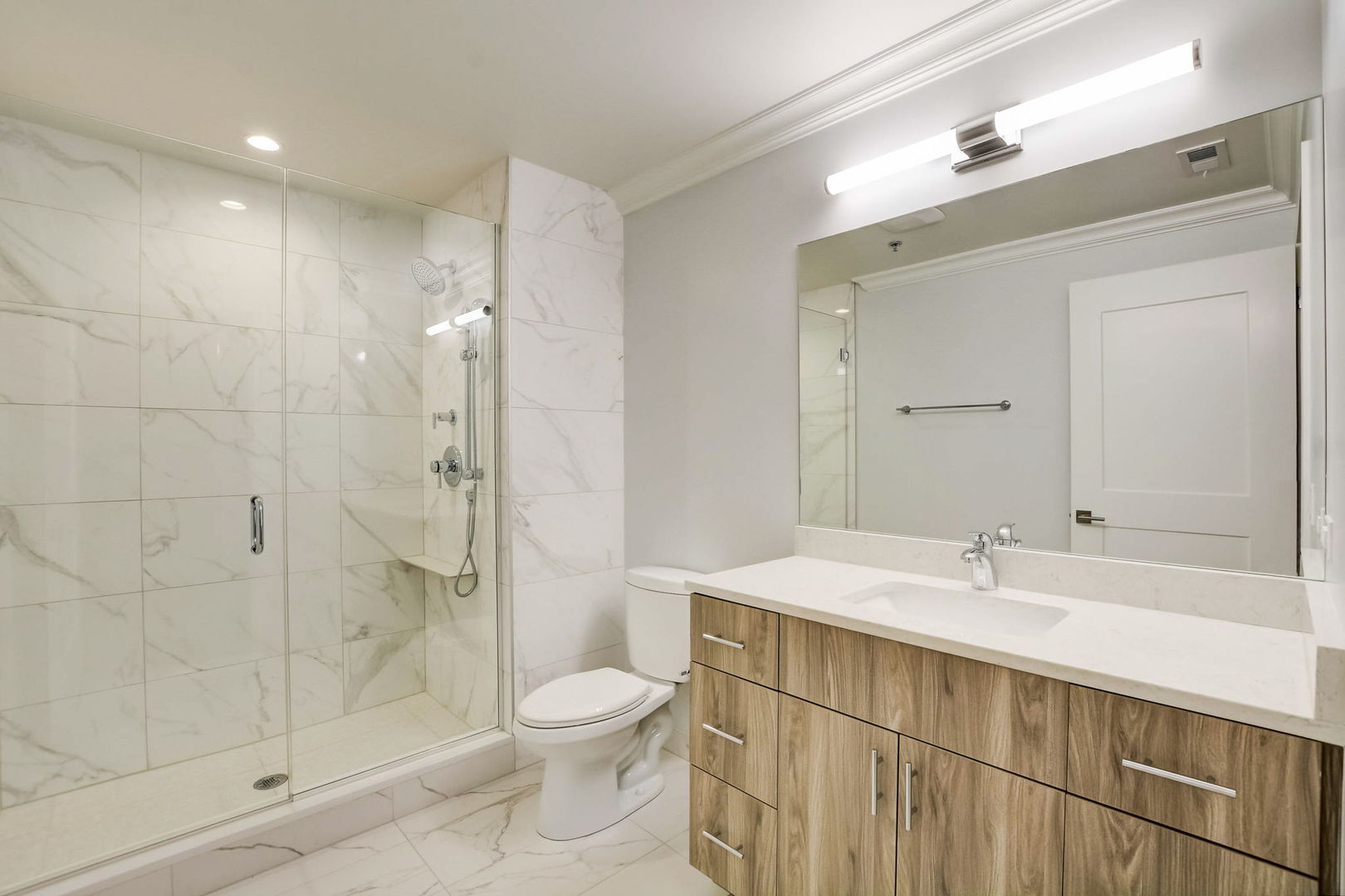 Undisclosed Address Chicago, IL 60607 - Photo 7 of 12 a bathroom with a sink a toilet and shower