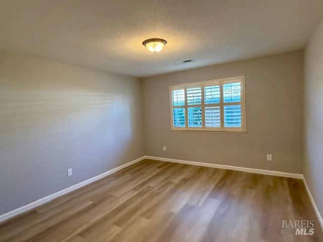 339 Twin Lakes Drive Santa Rosa, CA 95409 - Photo 10 of 15 wooden floor in an empty room with a window