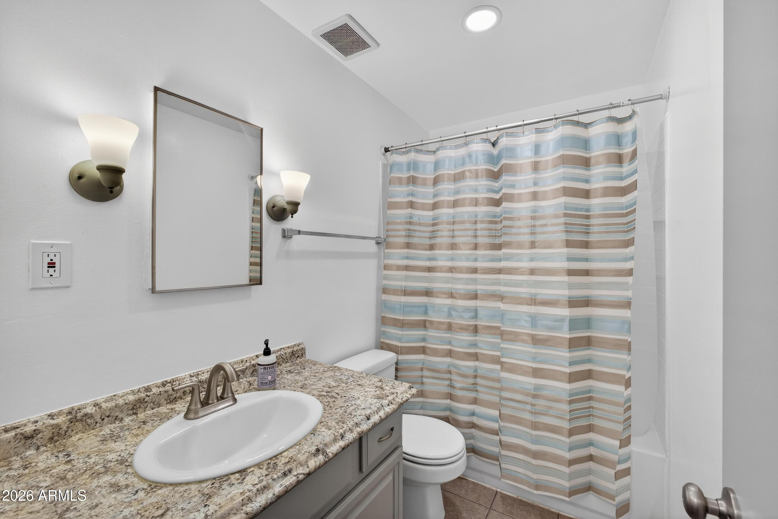 446 South Bellview Mesa, AZ 85204 - Photo 14 of 19 a bathroom with a granite countertop sink a toilet a mirror and shower curtain