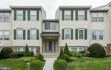a view of a front of a house with a garden