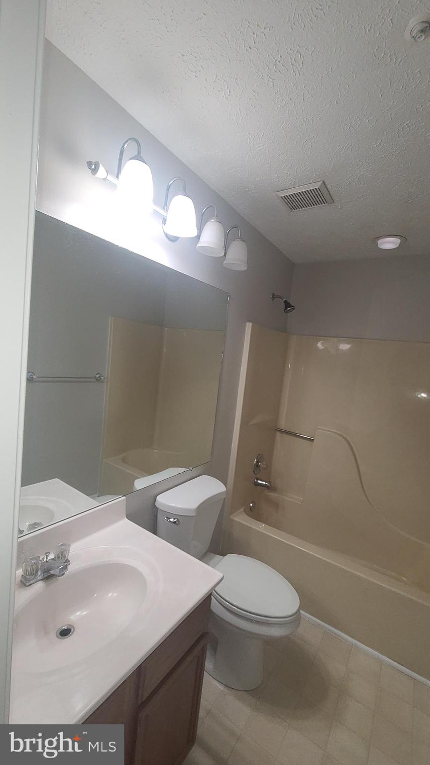 49 Bridle Lane, Unit 55 Nottingham, MD 21236 - Photo 14 of 17 a bathroom with a sink a toilet and shower