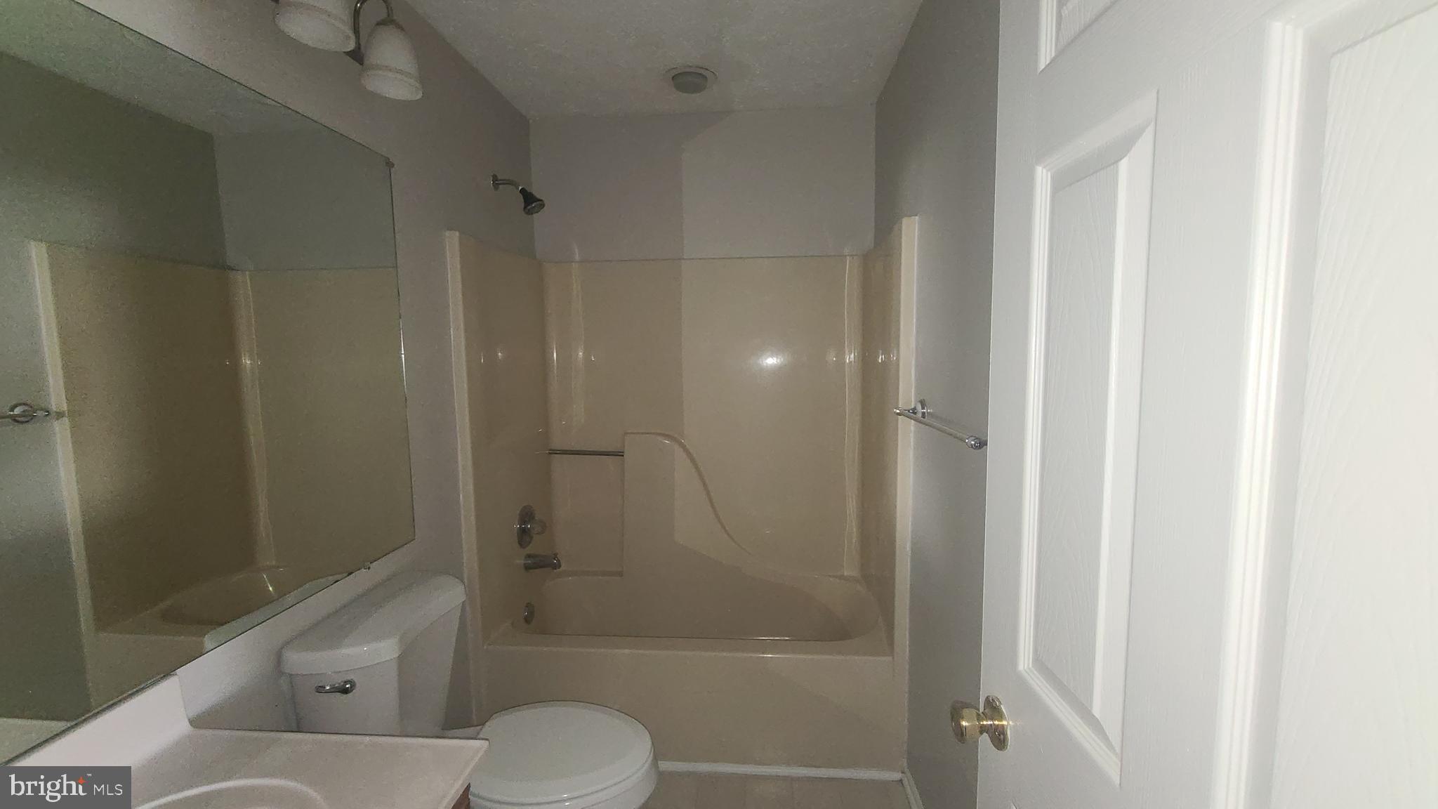 49 Bridle Lane, Unit 55 Nottingham, MD 21236 - Photo 15 of 17 a bathroom with a shower a toilet and a shower